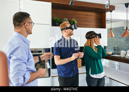 Paar tragen VR-Brille Einkaufen für eine neue Küche im Showroom Stockfoto