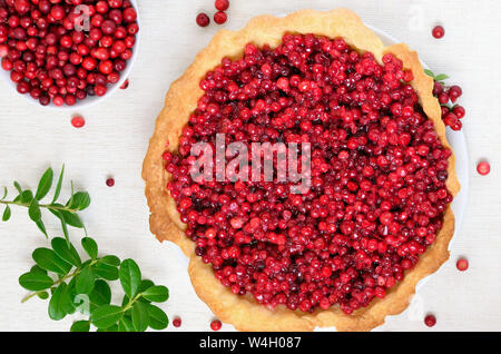 Appetitlich cowberry Pie und frischen Beeren cowberry auf weißem Hintergrund, Ansicht von oben Stockfoto