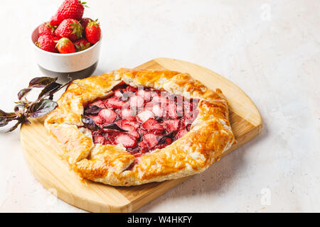 Hausgemachte Erdbeere öffnen pie Gallet mit lila Basilikum und Balsamico Dressing auf einem hellen Hintergrund. Für Text platzieren. Stockfoto