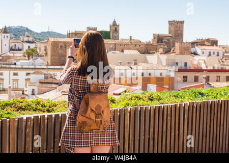 Junge Rothaarige touristische nimmt ein Foto von der Altstadt von Caceres aus der Sicht der Galarza Stockfoto