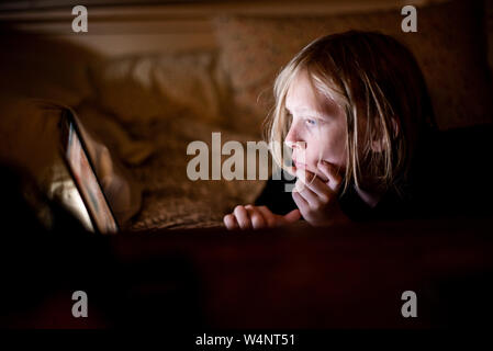 Kind auf dem Bildschirm in der Dunkelheit Stockfoto