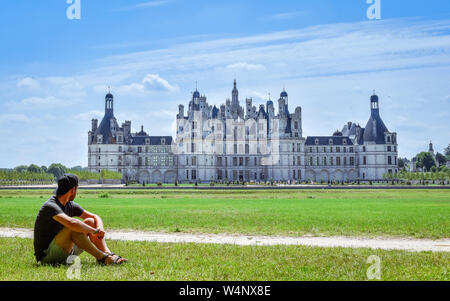 Athentic einsamen Reisenden an einem sonnigen Tag im Schloss Chambord suchen, saßen auf dem Gras. Frankreich Am 07. Juli 2017 Stockfoto