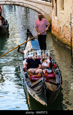 Italien, Venedig - 5 September, 2018: Männer gondolieri Gondeln fahren mit Touristen in Venedig in Italien. Stockfoto