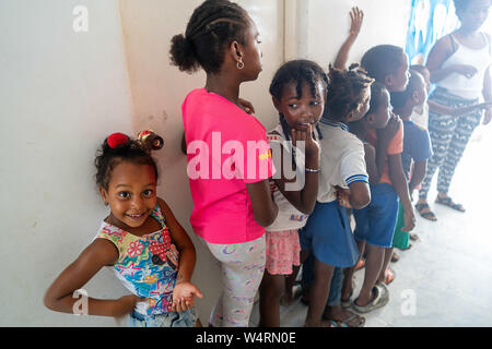 Juli 24, 2019, Cartagena, Bolivar, Kolumbien: Kinder, die in eine Warteschlange Geschenke an der La Boquilla erhalten, nachdem der Clean-up-Sitzung in Cartagena. Fundacion CoraJeM arbeitet bei der Aufklärung und die Schaffung von Möglichkeiten für die Menschen in Not. Lehrt sie, Kultur und Werte, der es Ihnen ermöglicht, bis zu einer besseren Zukunft und Leben mit mehr Würde bauen. Credit: Enzo Tomasiello/SOPA Images/ZUMA Draht/Alamy leben Nachrichten Stockfoto