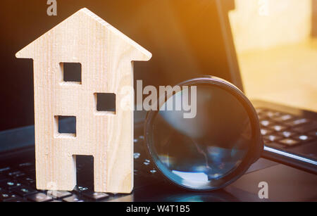 Haus und Lupe auf der Tastatur. Das Konzept der Wohnungssuche im Internet. Eine Wohnung für Verkauf online kaufen. Haus mieten. Verkaufen Prop Stockfoto