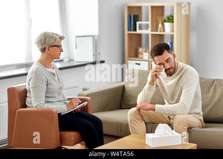 Ältere Frau, die Psychologin und weinenden Mann Patient Stockfoto