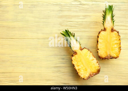 Hälften der süßen Ananas auf Holz- Hintergrund Stockfoto