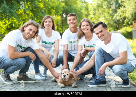 Freiwillige mit niedlichen Hund im Freien Stockfoto