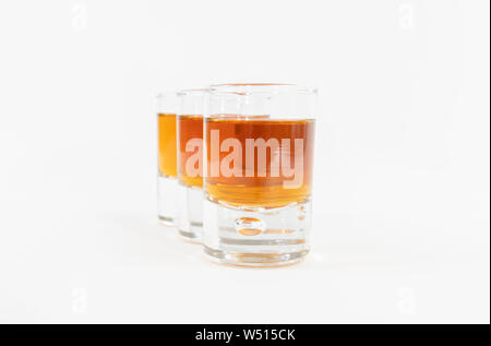 Luxuriöse und lecker Whiskey in drei Gläser aufgereiht und auf einem weißen Hintergrund - Close-up Stockfoto