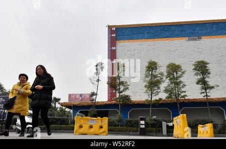 Fußgänger Spaziergang, vorbei an einem riesigen Thermometer mit Anzeige der aktuellen Außentemperatur in Chongqing, China, 4. Januar 2019. Stockfoto