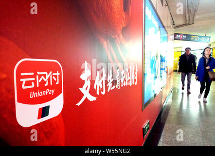 ---- Fußgänger vorbei an einer Werbung für China UnionPay in Shanghai, China, 20. Dezember 2018. Chinesische Finanzdienstleister UnionPay Stockfoto