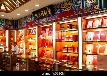 ---- Ein Mitarbeiter in einer Filiale von Peking Tongrentang oder Tong Ren Tang, die Traditionelle Chinesische Medizin Apotheke seit 1669, in Shanghai, Ch gesehen Stockfoto