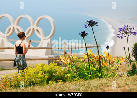 Portland. 26. Juli 2019. UK Wetter. Eine junge Frau blickt auf Sonnenverwöhnten Chesil Beach von Portlands olympische Denkmal 2012, auf einem anderen Backen - heißen Tag Credit: stuart Hartmut Ost/Alamy leben Nachrichten Stockfoto