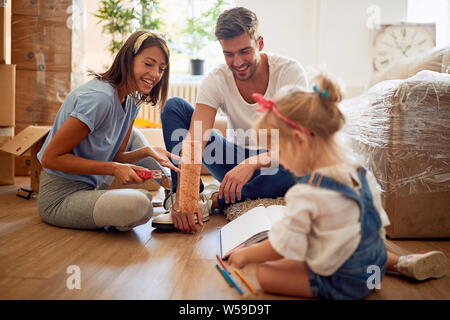 Glückliche Familie in das neue Haus auspacken Stockfoto