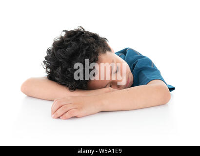 Ein wenig Junges Exausted faul Junge schlief auf weißer Tisch, Studio Shot, isoliert auf weißem Hintergrund Stockfoto