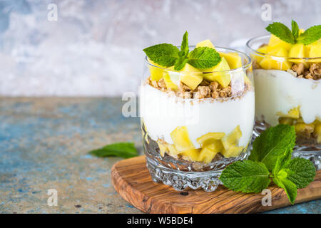 Parfait mit Joghurt, Mango und Müsli. Stockfoto