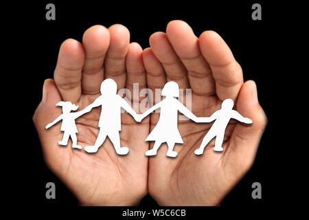 Person Hand hält Figuren, die Familie Stockfoto