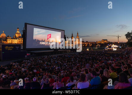 24 Juli 2019, Sachsen, Dresden: Zahlreiche Gäste der "Filmnächte am Elbufer" sitzen vor der Kulisse der Dresdner Altstadt mit der Kuppel des Kunstakedemie (L-R), der Frauenkirche, der hausmannsturm, der Hofkirche, der Semperoper und im Kino. Foto: Robert Michael/dpa-Zentralbild/dpa Stockfoto