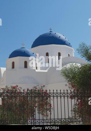 Ikonischen Blauen und Weißen Kuppelkirche und Garten in Santorini Stockfoto