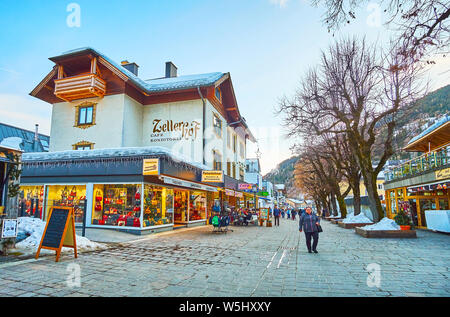 ZELL AM SEE, Österreich - 28. FEBRUAR 2019: Abend Spaziergang entlang der Geschäfte und Cafés der Altstadt, Touristen anzuziehen Souvenirs zu wählen oder Lokale genießen Stockfoto