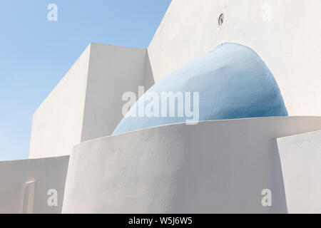 Zusammenfassung von Winkeln und Kurven von weißen Wänden und blauen Kuppeln der Gebäude in Megalochori, Santorin, Griechenland Stockfoto