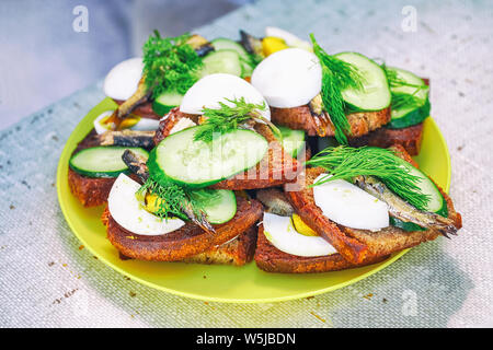 Sandwich aus Roggenbrot, Sprotten, Gurken, Ei, Dill Stockfoto