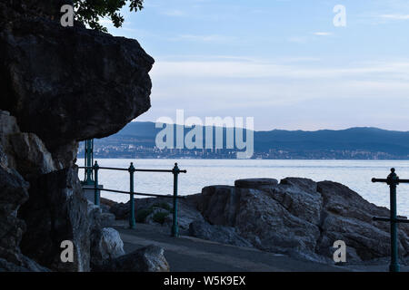 Twilight seascape von Riviera von Opatija in Kroatien. Blick auf die Stadt Rijeka. Schattierungen von Blau, dunkel Meerblick von der Küste. Stockfoto