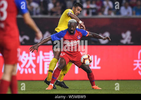 Brasilianische Fußballspieler Paulinho, oben, von Guangzhou Evergrande Taobao Herausforderungen Brasilianischen Fußballspieler Fernandinho Henrique von Chongqing SWM in Stockfoto