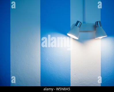 Wandleuchte in weiß und blau gestreiften Wand Hintergrund mit kopieren. Stockfoto