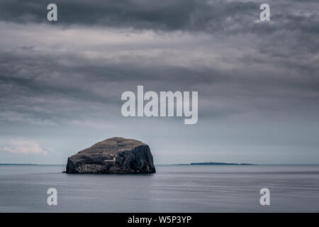 Dunkle Wolken über den Leuchtturm am Bass Rock im Firth von weiter in der Nähe von North Berwick an der Ostküste von Schottland Stockfoto