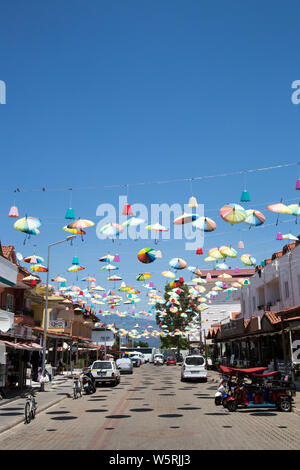 Celebratory brollies ausgesetzt über eine Straße in Icmeler, Provinz Mugla, Türkei. Stockfoto