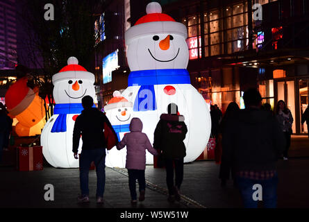 Riesige beleuchtete Dekorationen mit der Form der Schneemänner sind angezeigt das bevorstehende Weihnachtsfest vor einem Einkaufszentrum in Sheny zu markieren Stockfoto