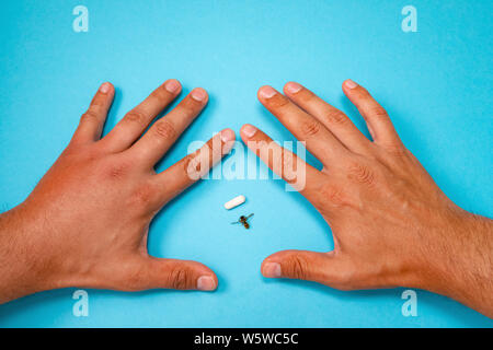 Männliche hand von Biene gestochen und Medikamente für Sie Schwellungen. Hand, Schwellungen, Entzündungen, Hautrötungen sind Anzeichen einer Infektion. Insekt beißt und Pillen auf b Stockfoto