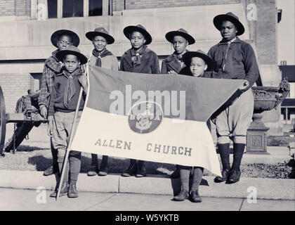 1930er Jahre GRUPPE DER AFRIKANISCHEN AMERIKANISCHEN PFADFINDER UND MANN FÜHRER BETRACHTEN KAMERA HALTEN FAHNE MIT BSA INSIGNIA-b3763 HAR 001 HARS INSPIRATION PFADFINDER MÄNNER VERTRAUEN AUSDRÜCKE B&W AUGENKONTAKT FREIHEIT ERFOLG GLÜCK FRÖHLICHEN ABENTEUER STÄRKE afrikanische Amerikaner, AFRICAN-AMERICAN, FREIZEIT SCHWARZ ETHNIZITÄT RICHTUNG STOLZ GELEGENHEIT BERUFE BOY SCOUT VERBINDUNG THRIFTY ZUVORKOMMEND freundliche und hilfsbereite Art REVERENT STILVOLLE vertrauenswürdig Wachstum von Jungfischen treu vor - jugendlich PRE-TEEN BOY ENTSPANNUNG ZWEISAMKEIT Truppe junger erwachsener Mann vorbereitet, SCHWARZ UND WEISS BRAVE HAR 001 gehorsam sein ALT ALTMODISCH Stockfoto