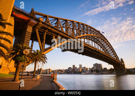 Horizontales Bild der Sydney Harbour Bridge in Sydney, Australien, bei Sonnenaufgang von Hickson Road finden. Stockfoto