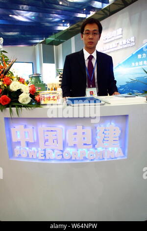 ---- Ein chinesischer Mitarbeiter ist auf dem Stand der Power Construction Corporation von China während der 2011 China International Industry Fair gesehen in Shangh Stockfoto