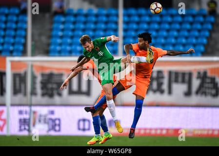 Kroatischer Fußballspieler Nikica Jelavic, Mitte, von Guizhou Hengfeng Köpfe die Kugel ein Pass gegen den brasilianischen Fußballspieler Gil von Shandong Lun zu machen Stockfoto