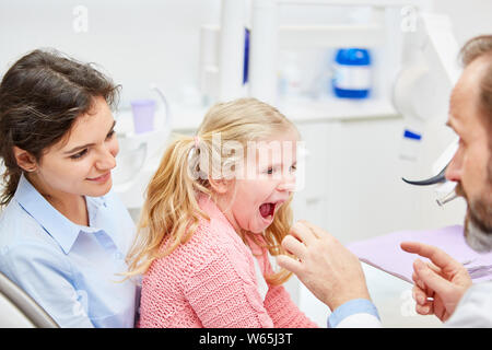 Zahnarzt in Absprache mit Mutter und Kind schafft Vertrauen auf vor der Prüfung Stockfoto