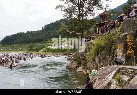 Ein Mann der Zhuang, die ethnischen Minderheiten angehören, springt ins Wasser Das Wasser springen Tiaoshui Festival (Festival) in Congjiang County, qiandongnan Miao zu feiern. Stockfoto