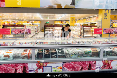 ---- Ein Kunde Geschäfte für Fleisch in einem Supermarkt in Shanghai, China, 12. Juni 2018. Chinas Verbraucherpreisindex (VPI), ein Hauptindikator der Inflationsrate. Stockfoto