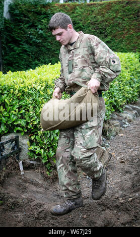 Ein Soldat von 2 Yorks Stapel Sandsäcke in Grinton, North Yorkshire, nachdem Teile der Region hatte bis zu 82,2 mm Regen in 24 Stunden am Dienstag. Stockfoto