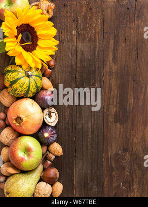 Herbst Grenze aus Obst, Gemüse, Pilze, Nüsse und Sonnenblumenkerne auf einem Holztisch Stockfoto