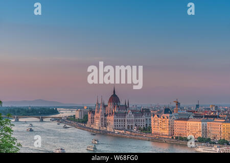 Panorama von Budapest bei Sonnenuntergang. Ungarische Wahrzeichen: Die Kettenbrücke, das Parlament und die Donau in Budapest. Stockfoto