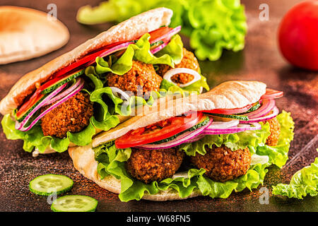 Falafel und frisches Gemüse in pita Brot auf dunklem Hintergrund. Stockfoto