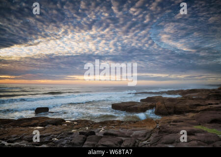 Am Abend licht Wärme auf die Brandung und Basalt Shoreline entlang der zentralen Oregon Coast in Yachats. Stockfoto