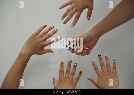 Weibliche Fußball-Fans zeigen ihre Nail Art Design durch die FIFA WM 2018 in Liaocheng city inspiriert, der ostchinesischen Provinz Shandong, 11. Juni 2018. Stockfoto