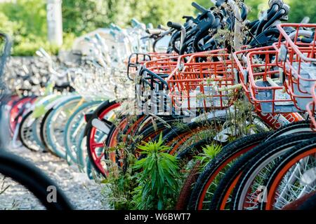 Verlassene Fahrräder der Chinesischen bike-sharing Dienste werden auf einem Parkplatz in der Nähe des Bund in Shanghai, China, 11. Mai 2018 aufgetürmt. Stockfoto