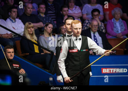 Anthony McGill von Schottland vertritt einen Schuß zu Ryan Tag von Wales in der ersten Runde im Jahr 2018 Betfred World Snooker Championship an der Stockfoto