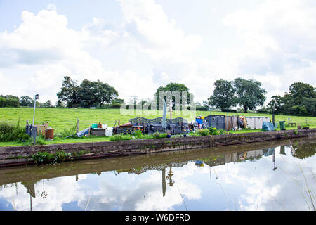 Reservierter Liegeplatz Platz für einen schmalen Boot genannt Moor Zeit mit eigenem Garten, und Messe, auf der Trent und Mersey Canal in Cheshire UK Stockfoto