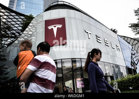 ---- Fußgänger vorbei an einer Händlerniederlassung Store von Tesla in Guangzhou City, der südchinesischen Provinz Guangdong, am 1. November 2017. Chinas Entscheidung zu Stockfoto